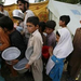 children-queue-up-to-get-hot-tea-at-a-refugee-camp-in-mardan-in-